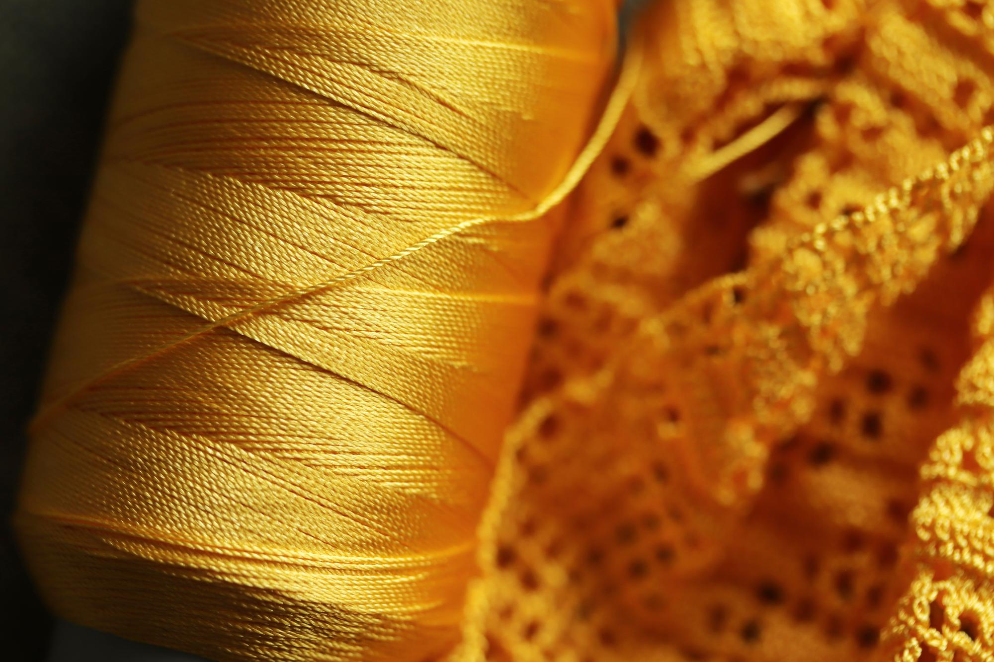 close-up of gold thread embroidery on silk